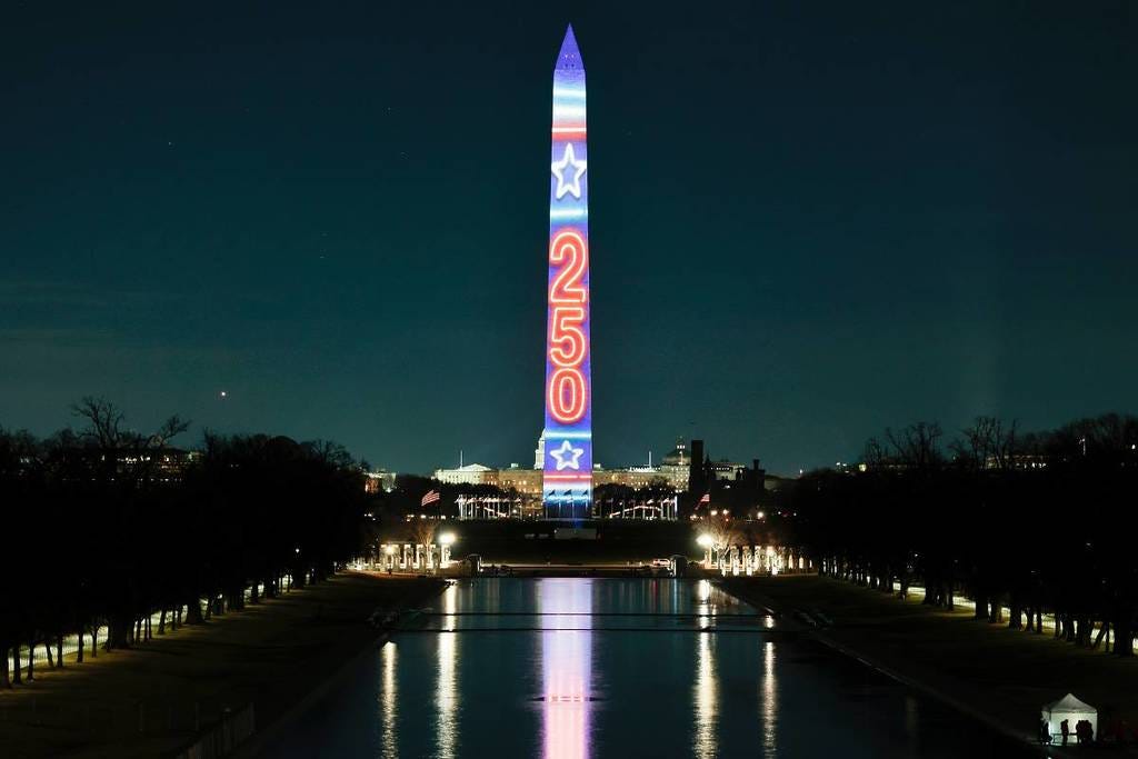 The Washington Monument Glows As The 'World's Tallest Birthday Candle' To  Kick Off America's 250th Anniversary