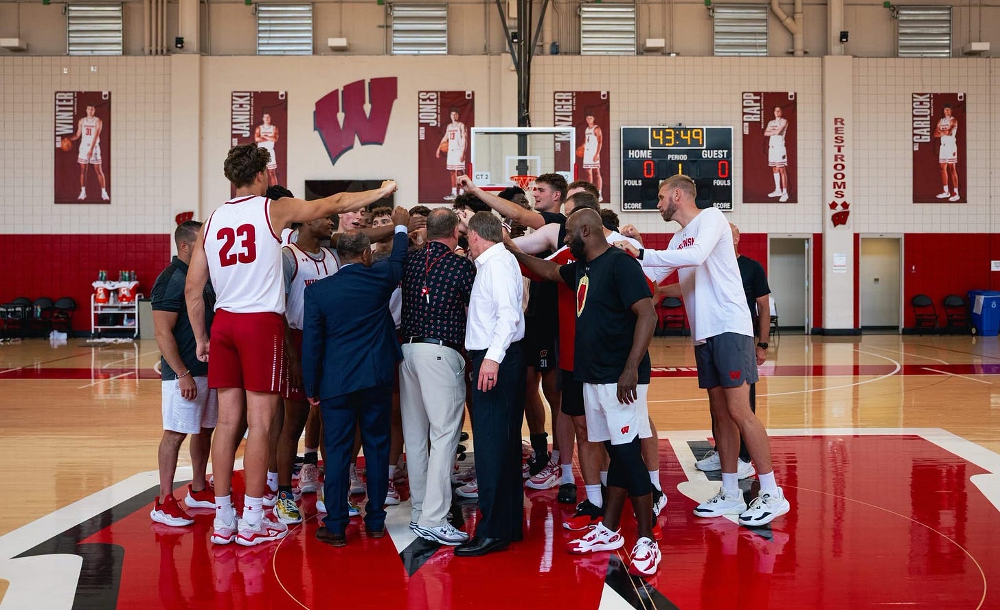 Wisconsin men's basketball players and coaches gather in a huddle inside the Nicholas-Johnson Pavilion after a summer practice. Wisconsin men's basketball players and coaches gather in a huddle inside the Nicholas-Johnson Pavilion after a summer practice.