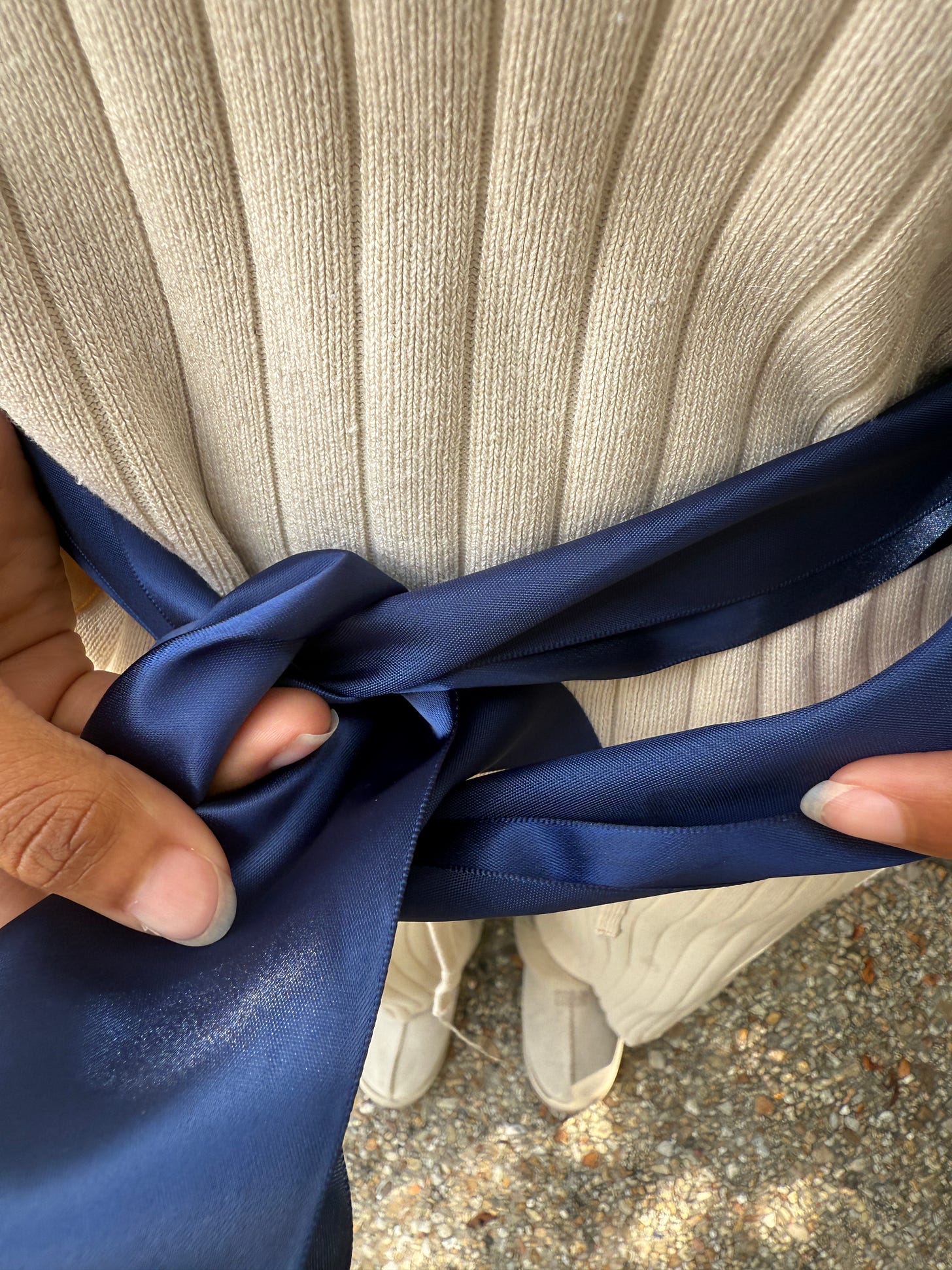Wrapping the top ribbon piece over and around the first loop