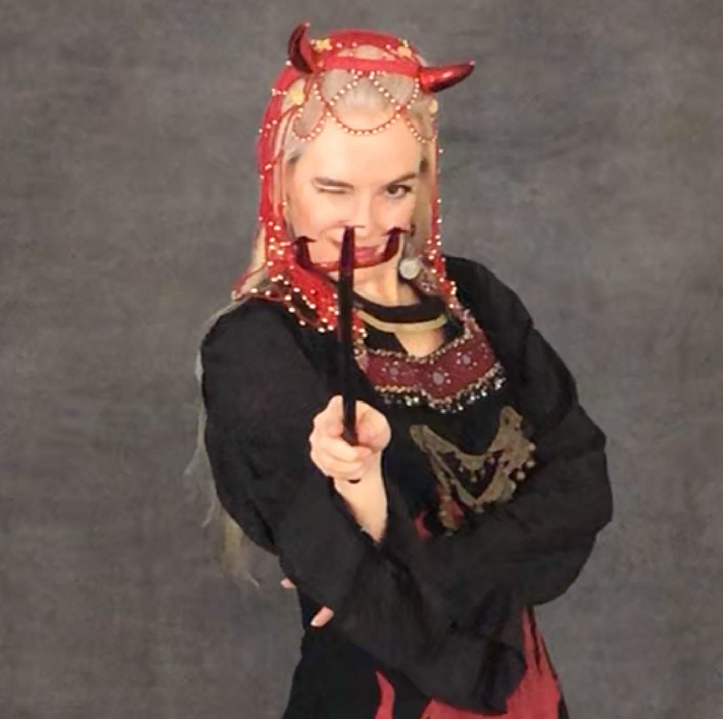 The author in devil horns and fire coat, pointing a pitchfork at you and winking.
