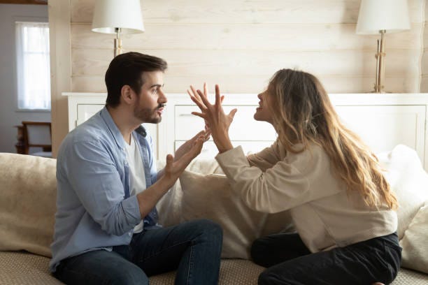 Emotional annoyed stressed couple arguing at home. Emotional annoyed stressed couple sitting on couch, arguing at home. Angry irritated nervous woman man shouting at each other, figuring out relations, feeling outraged, relationship problems concept. man woman arguing stock pictures, royalty-free photos & images