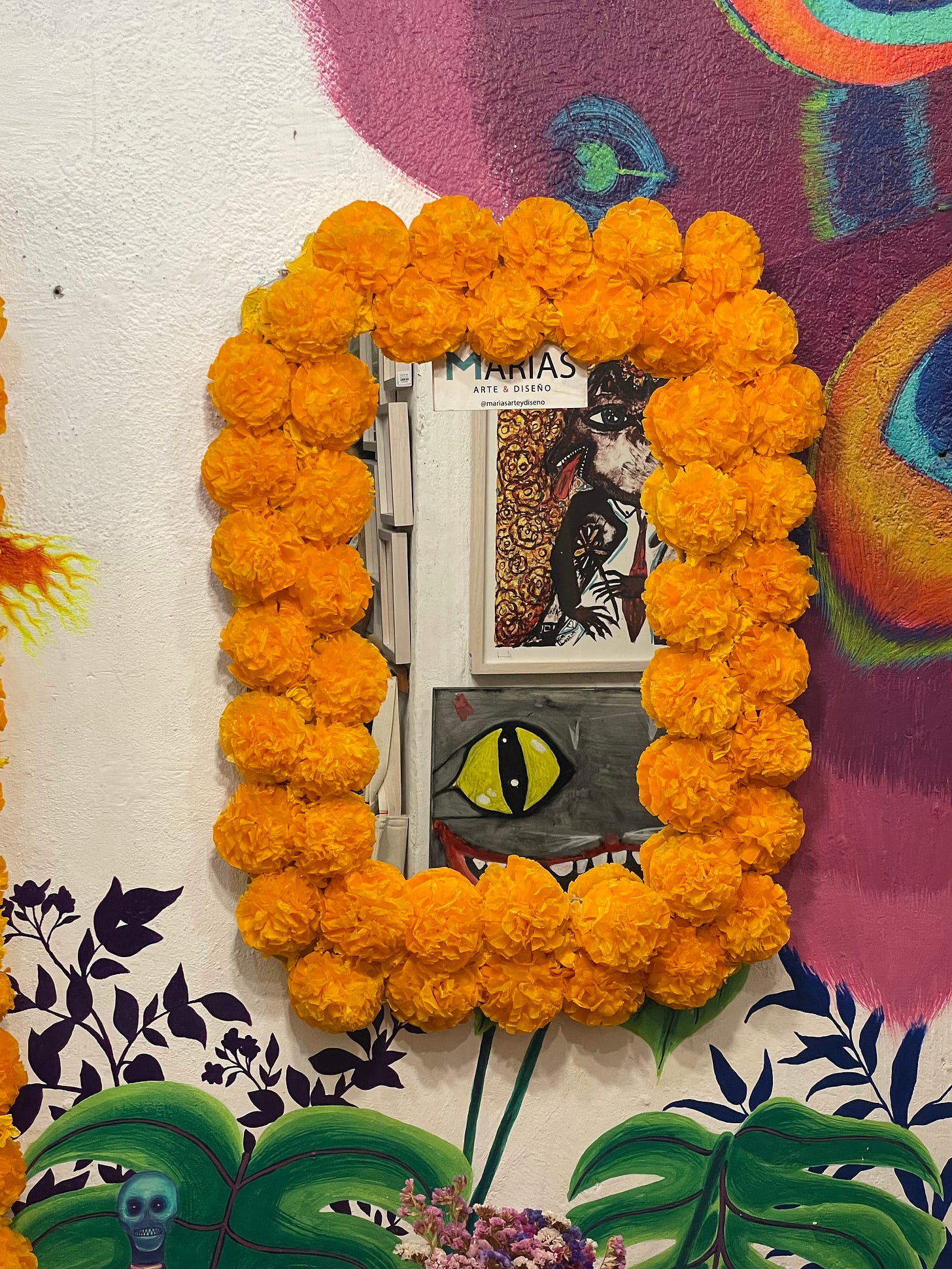A mirror surrounded by paper flowers at the shop Maria's Art y Diseño. A mirror surrounded by paper flowers at the shop Maria's Art y Diseño.