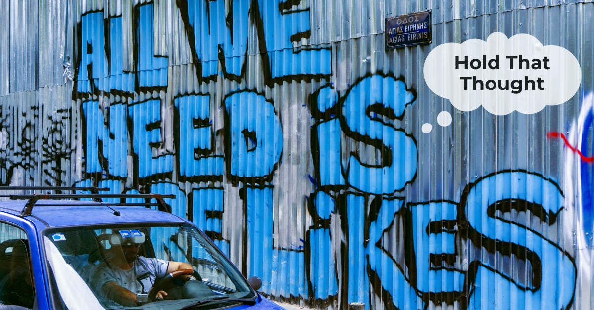 Corrugated metal wall with graffiti that says "All we need is more likes"