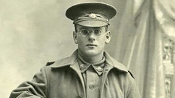 uncoloured image of a man in historic army uniform with capped hat and glasses