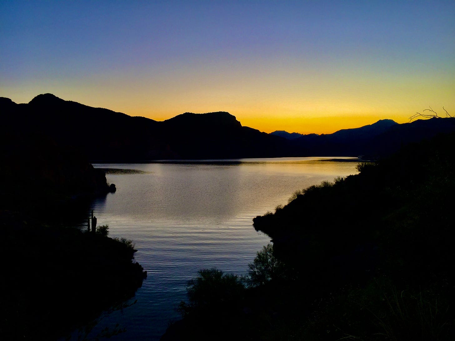 a part of canyon lake just before the sun peaks over the mountains