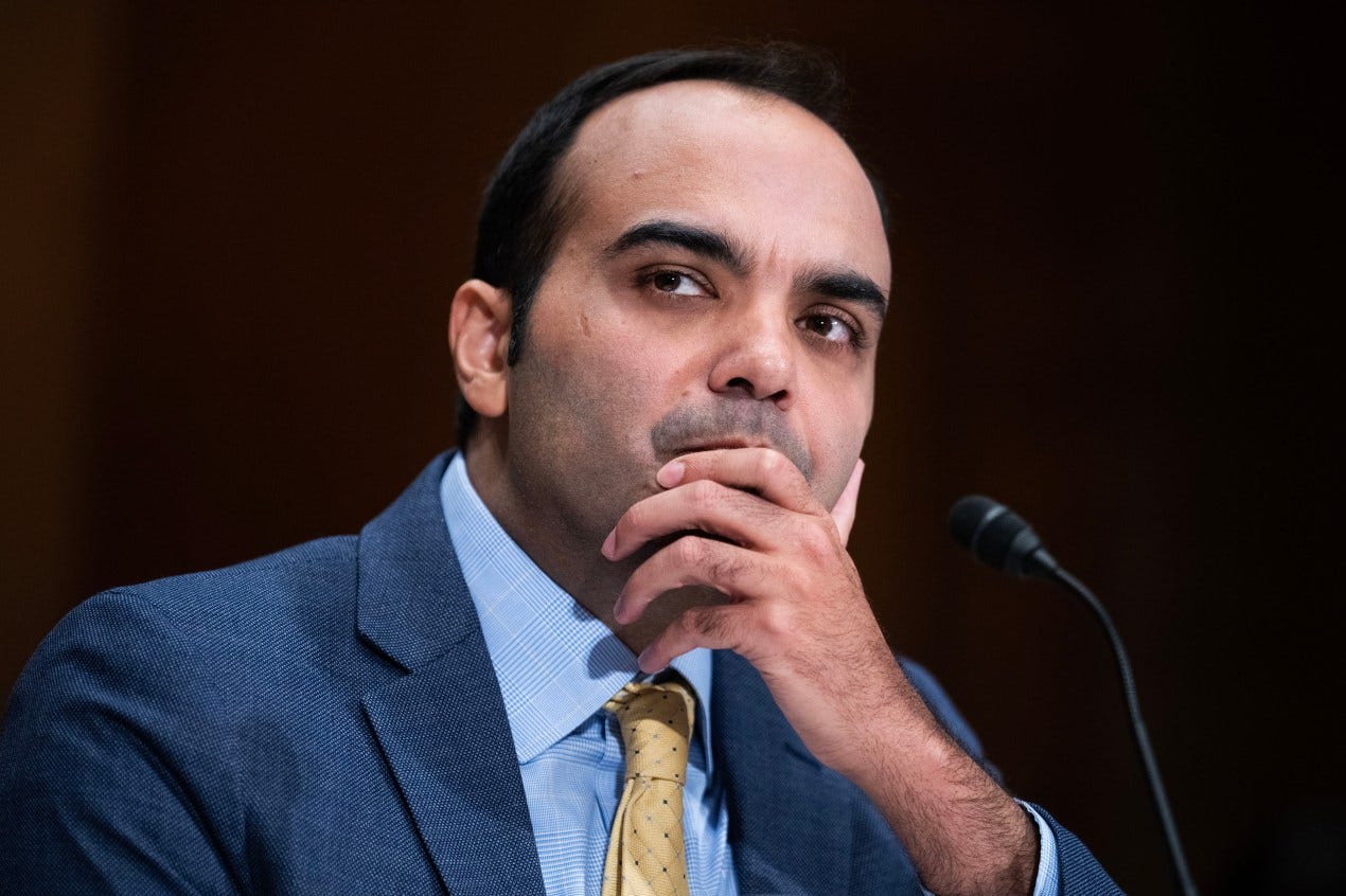 A photograph of Rohit Chopra during the senate hearing. He holds his chin in his left hand in a contemplative position. A photograph of Rohit Chopra during the senate hearing. He holds his chin in his left hand in a contemplative position.
