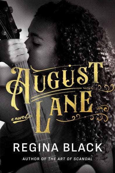August Lane by Regina Black. The book cover is in black and white, and features a close up of a Black woman with her back turned looking a little over her shoulder. She's holding a guitar over her shoulder, too. The font the title is in is a little western.