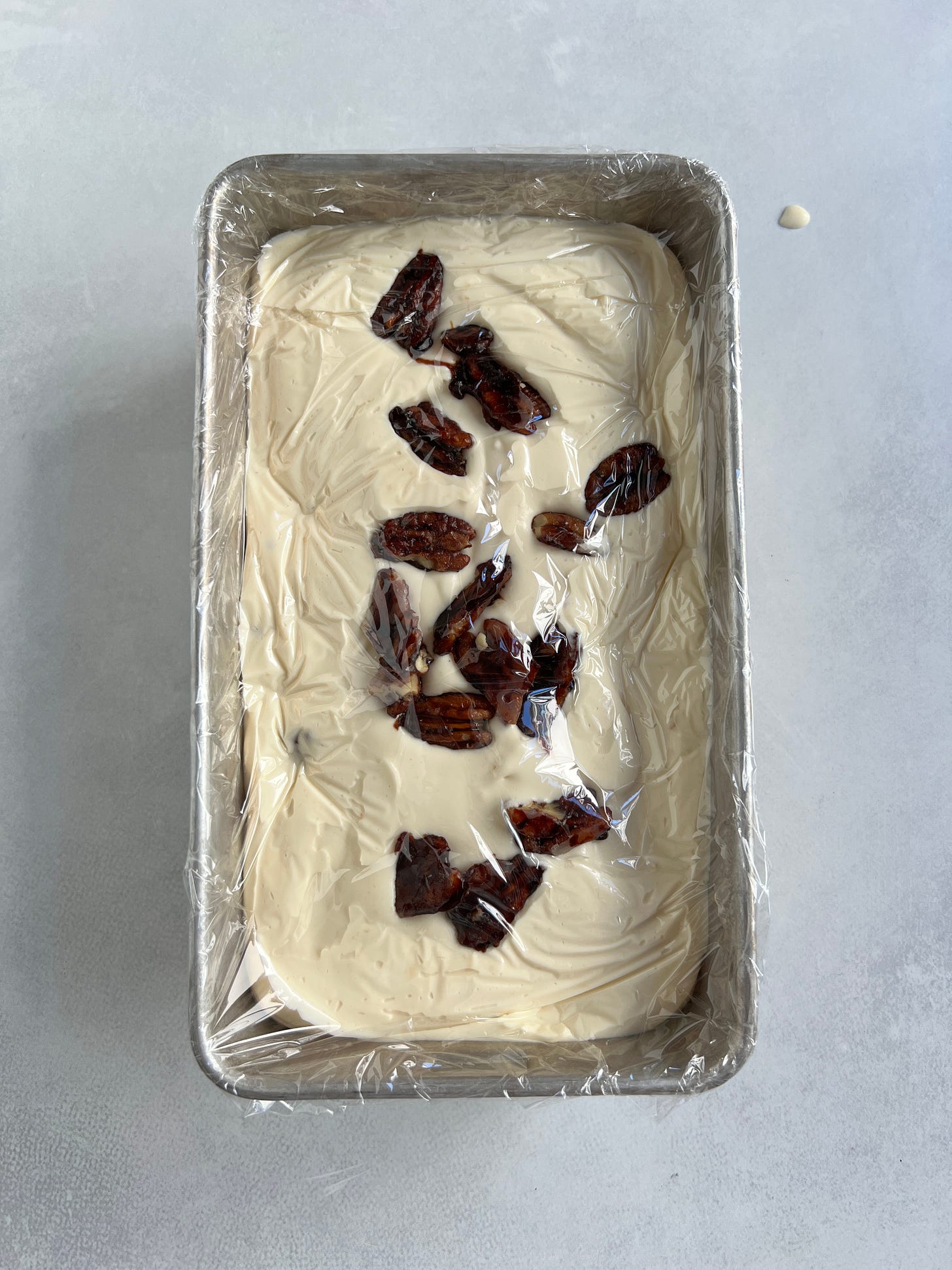 Butter pecan ice cream in a loaf pan ready for the freezer. Butter pecan ice cream in a loaf pan ready for the freezer.