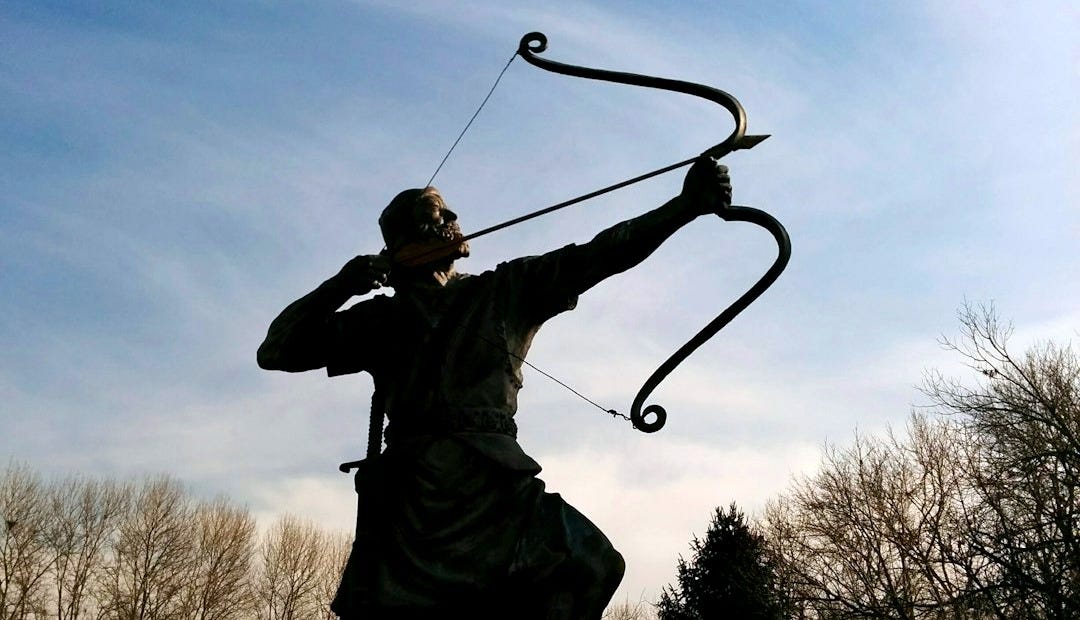 man holding archer statue