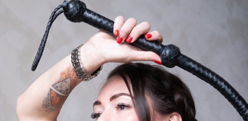 a woman with a tattoo on her arm holding a hair dryer a woman with a tattoo on her arm holding a hair dryer