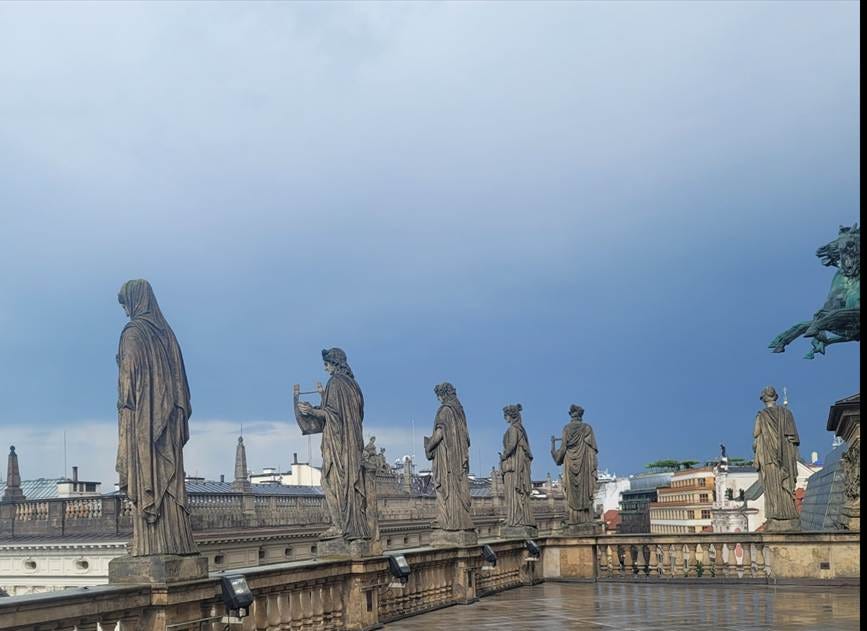 A group of statues on a roof

AI-generated content may be incorrect.