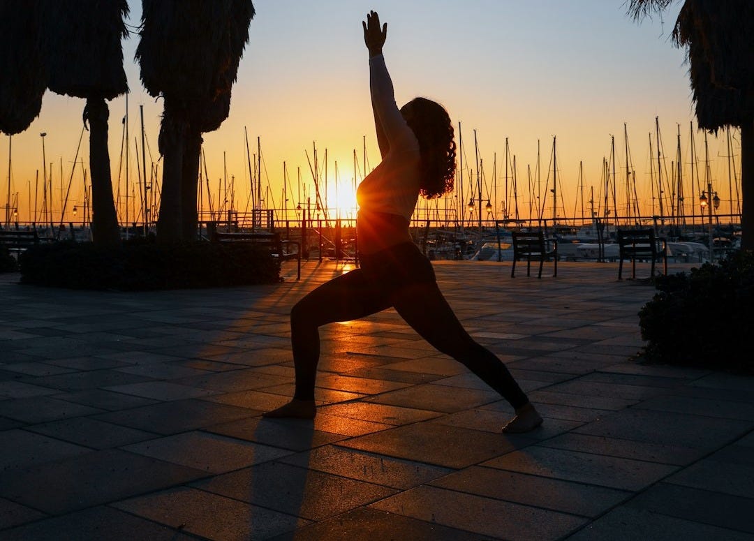 woman standing while dancing on pathway woman standing while dancing on pathway