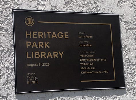 Ribbon Cutting, Chris Slama, and a mom and chld inside the library