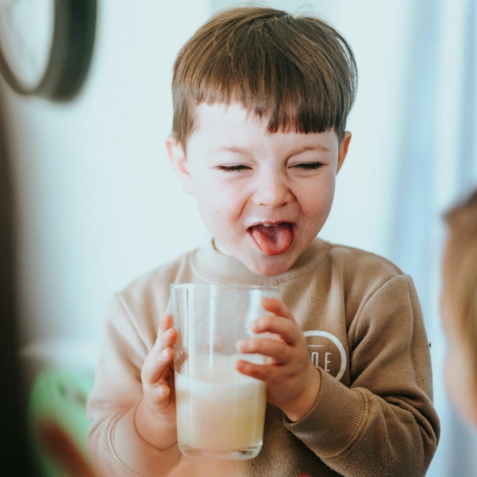 boy in brown long sleeve shirt holding clear glass jar boy in brown long sleeve shirt holding clear glass jar