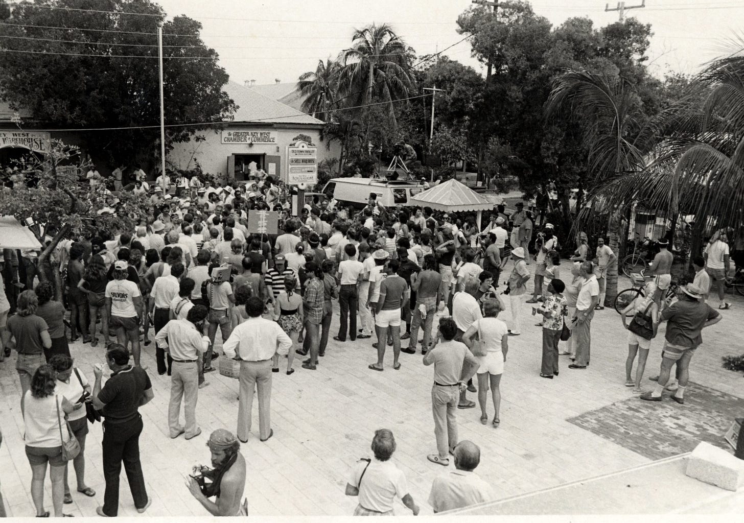 A group of people in a plaza
A group of people in a plaza
