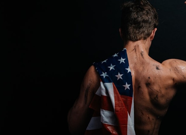 a man with an american flag on his back a man with an american flag on his back