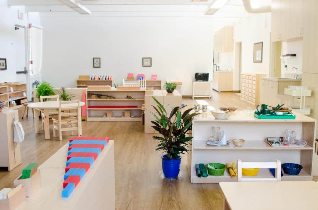 Empty Montessori classroom with prepared shelves, pink tower, and red and blue rods — what is Montessori learning space
