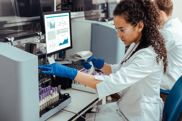 Smart nice woman looking at the test tube Focused on work. Smart nice woman looking at the test tube while being focused on her work medical lab stock pictures, royalty-free photos & images