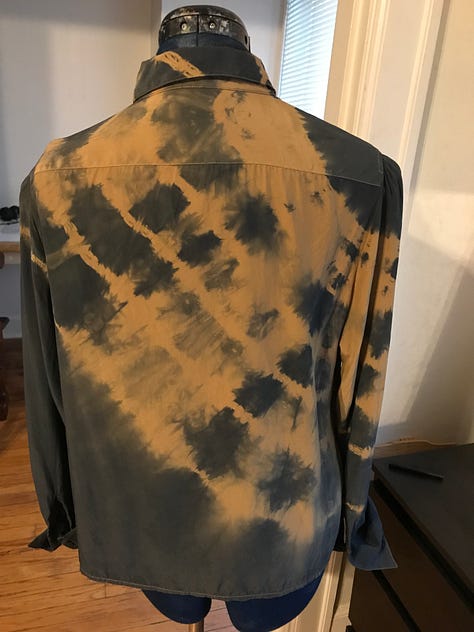 A dress, a handbag and a top with dye and paint treatments.