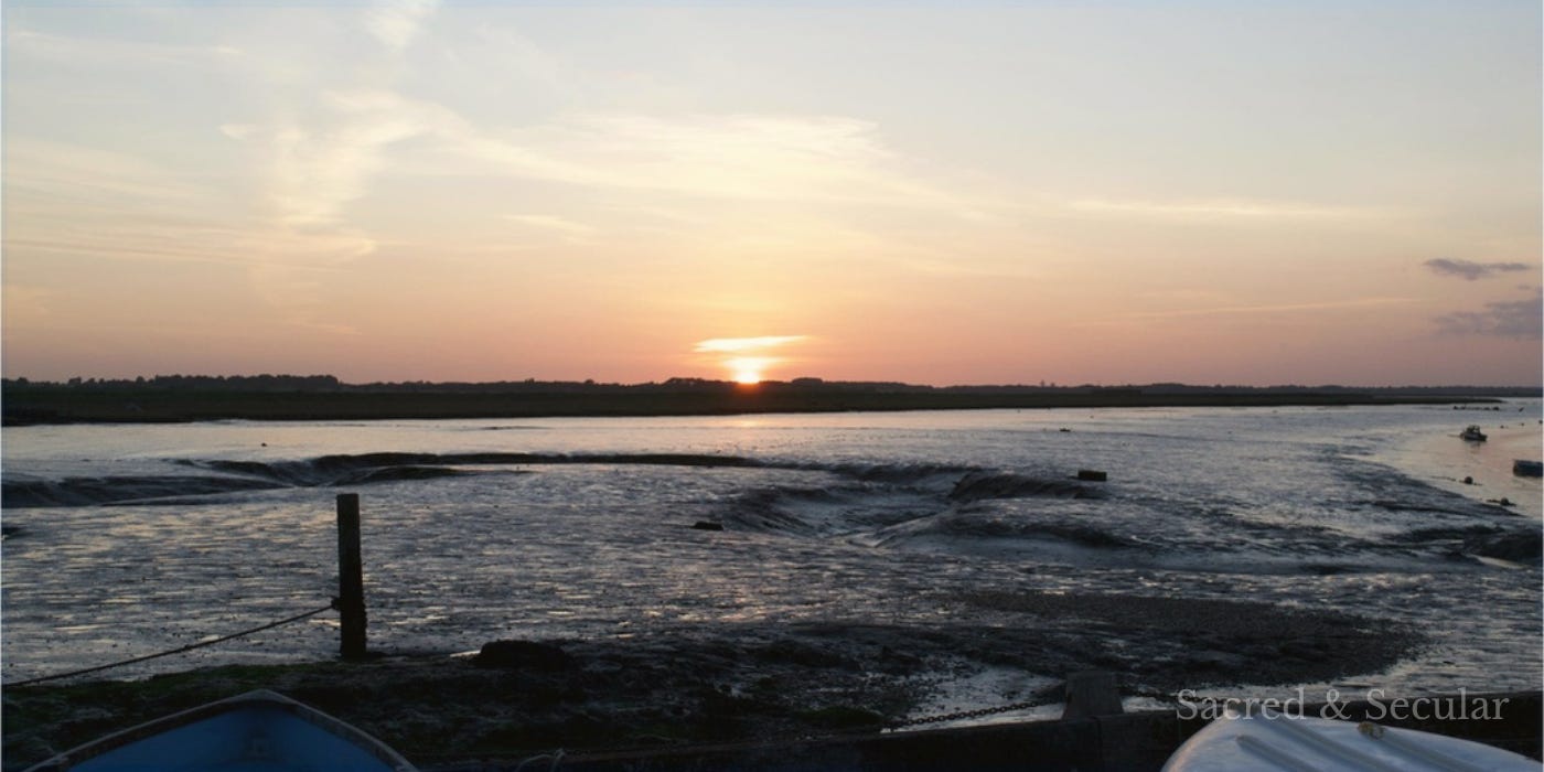 river at sunset with boats in foreground river at sunset with boats in foreground