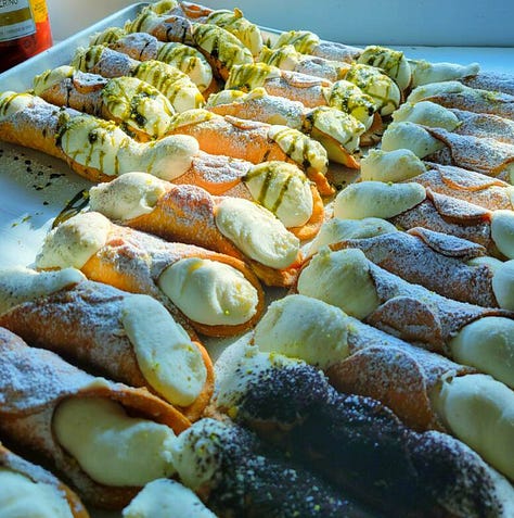 stuffed cannoli's, gelato on a cone, gelato frozen in stainless steel tub.