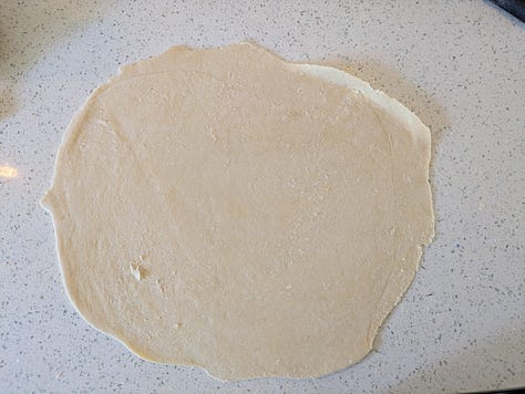 Rolling and fitting the dough. I once rolled dough with a very large carrot when I didn't have a rolling pin. Feel free to improvise