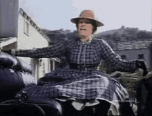 gif of a woman in a large plaid dress fainting backwards out of an open carriage gif of a woman in a large plaid dress fainting backwards out of an open carriage