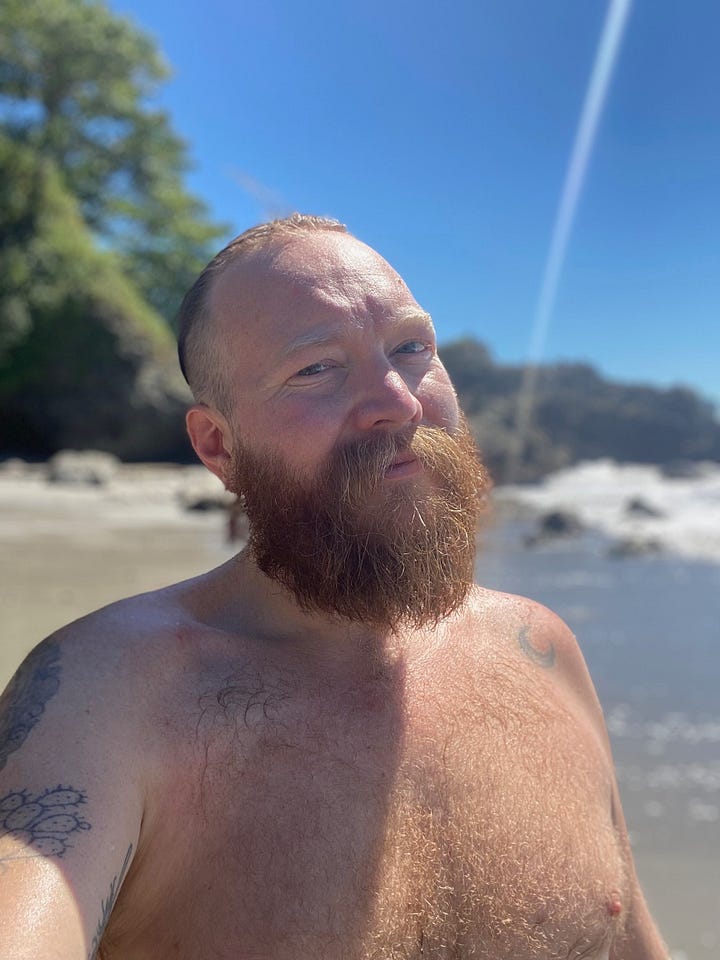 The pristine white beaches of Playitas and handsome bearded queer smiles as he sun basks in the glory of gay paradise in Costa Rica's Playitas Beach in Manuel Antonio