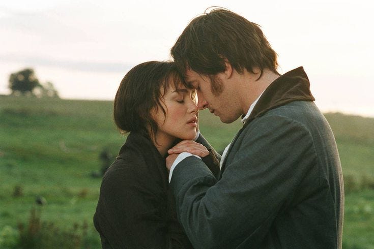 This may contain: a man and woman standing next to each other in a field