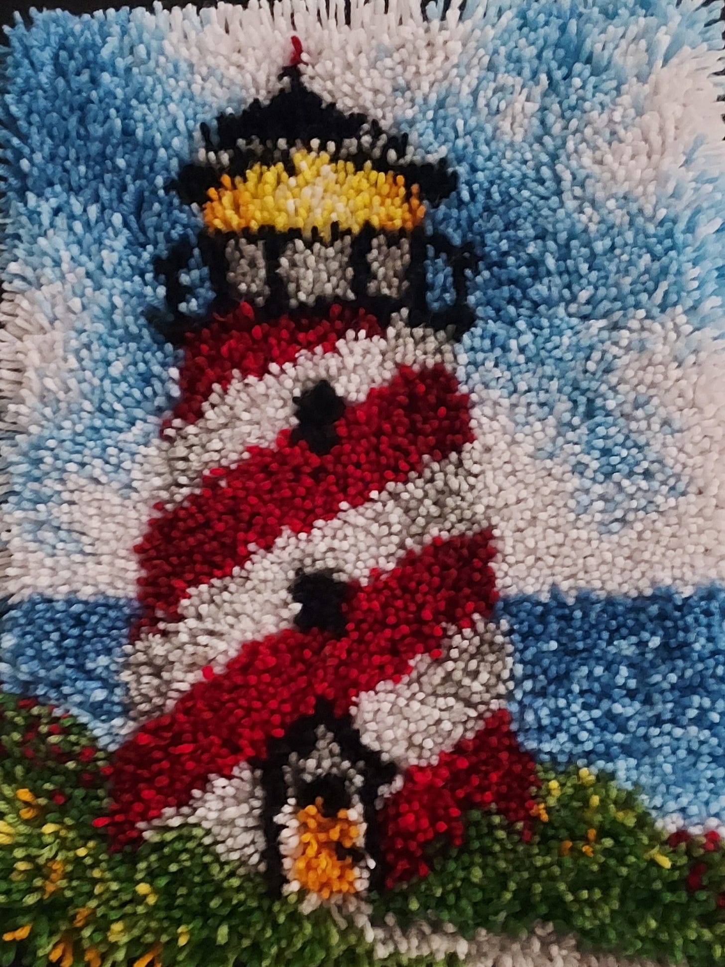 A red and white striped lighthouse on a blue and white carpet

AI-generated content may be incorrect.