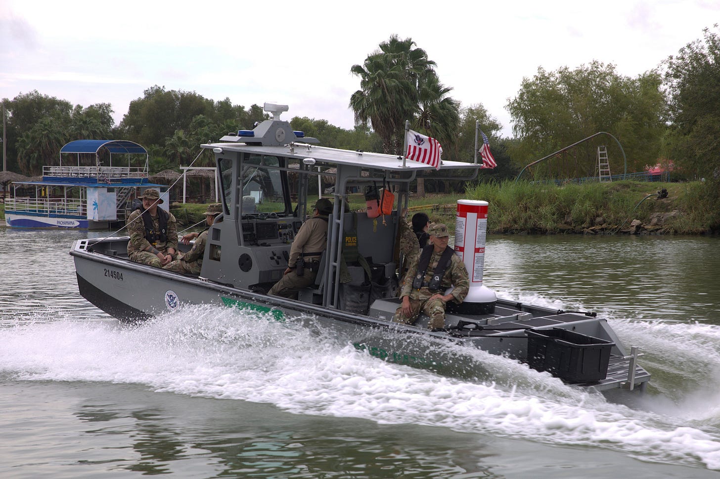 Soldiers aboard a Department of Homeland Security patrol boat participating in “Operation River Wall” drop buoys on the Rio Grande warning (in English & Spanish) against illegal crossings. Soldiers aboard a Department of Homeland Security patrol boat participating in “Operation River Wall” drop buoys on the Rio Grande warning (in English & Spanish) against illegal crossings.