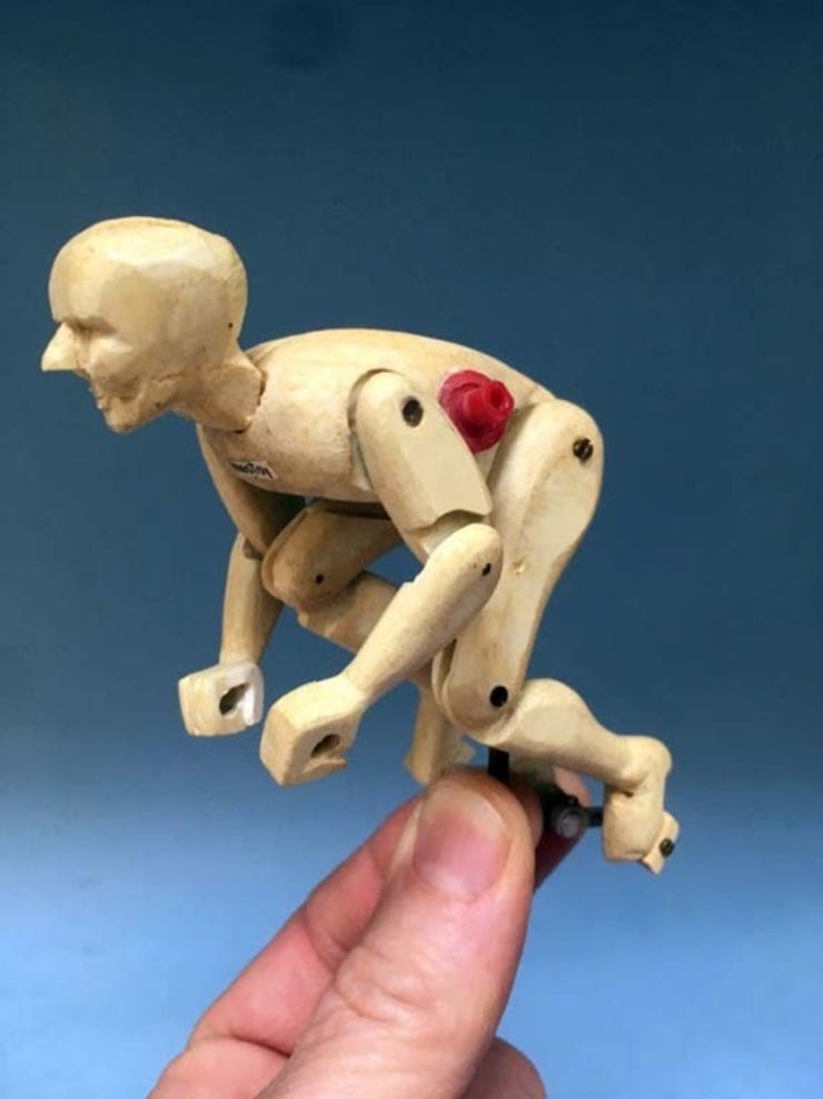 Hand-carving a figure out of layered styrene.