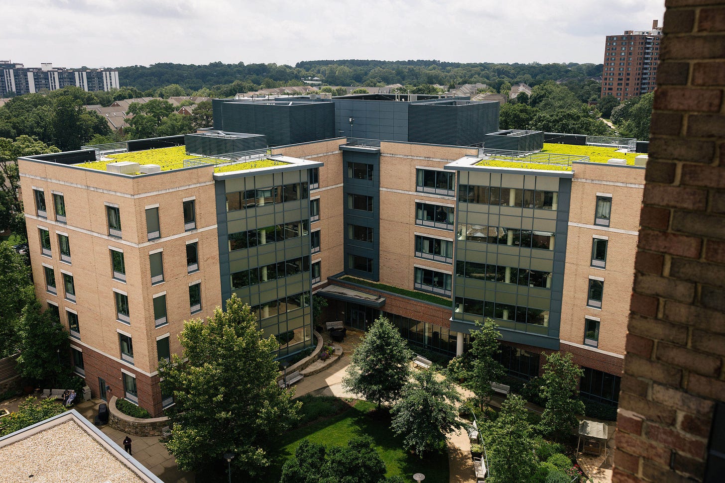 An arial shot of a 5-story modern nursing home building. An arial shot of a 5-story modern nursing home building.