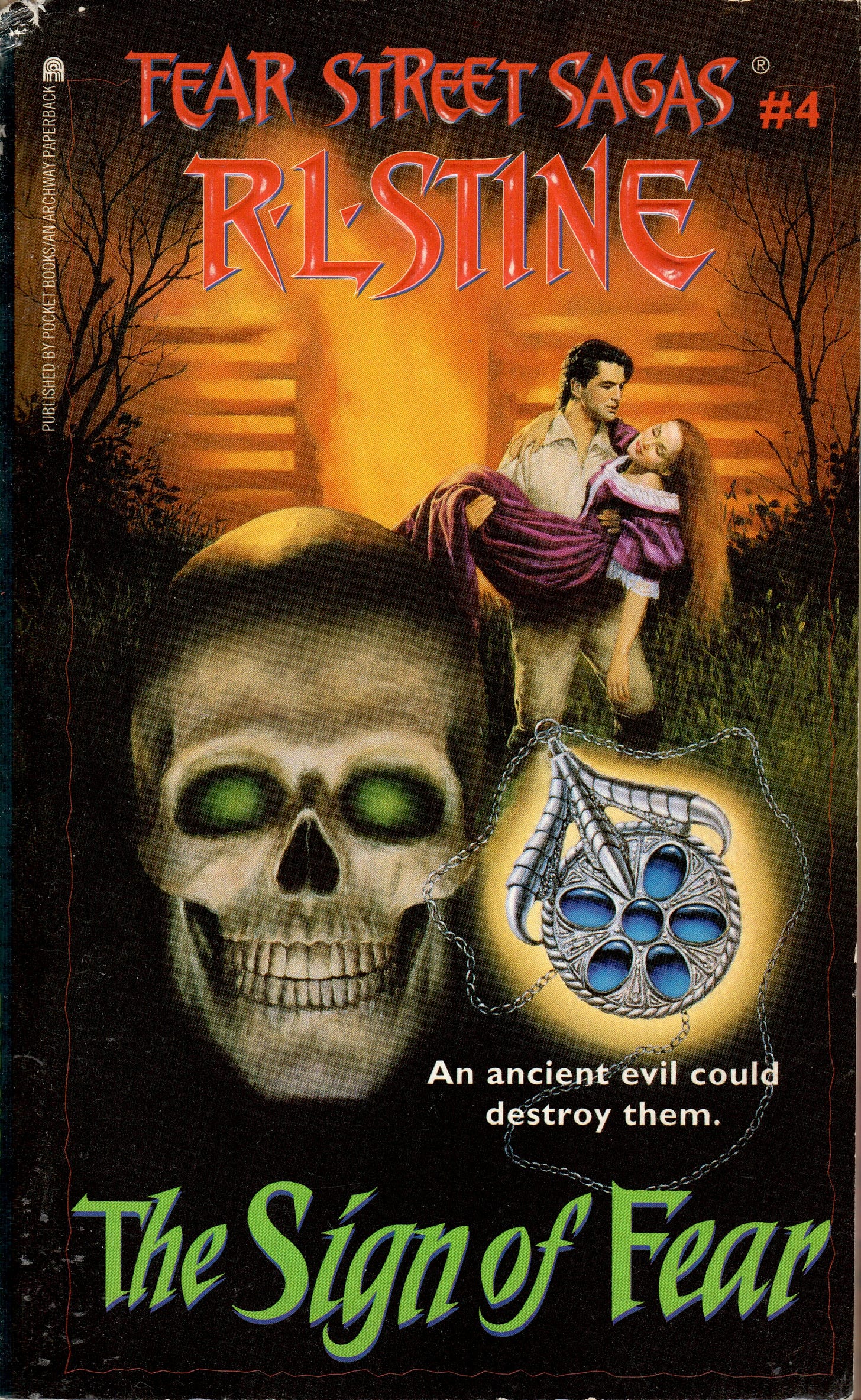 a man is holding a woman next to a burning building, there's also a skull, and a silver pendant with blue stones