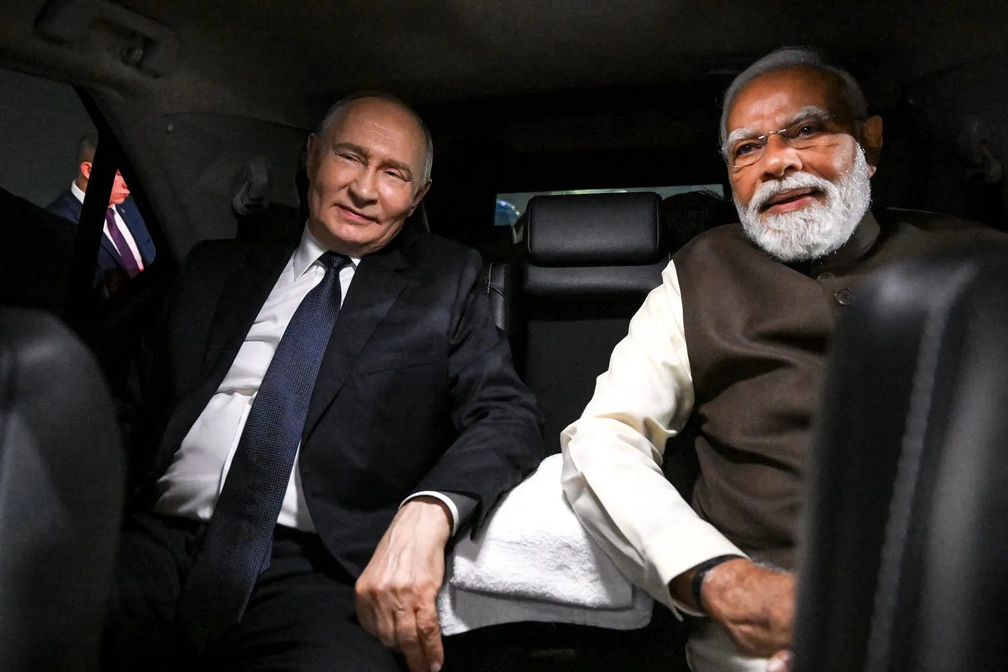 Russian President Vladimir Putin and Indian Prime Minister Narendra Modi sit in a car in New Delhi.