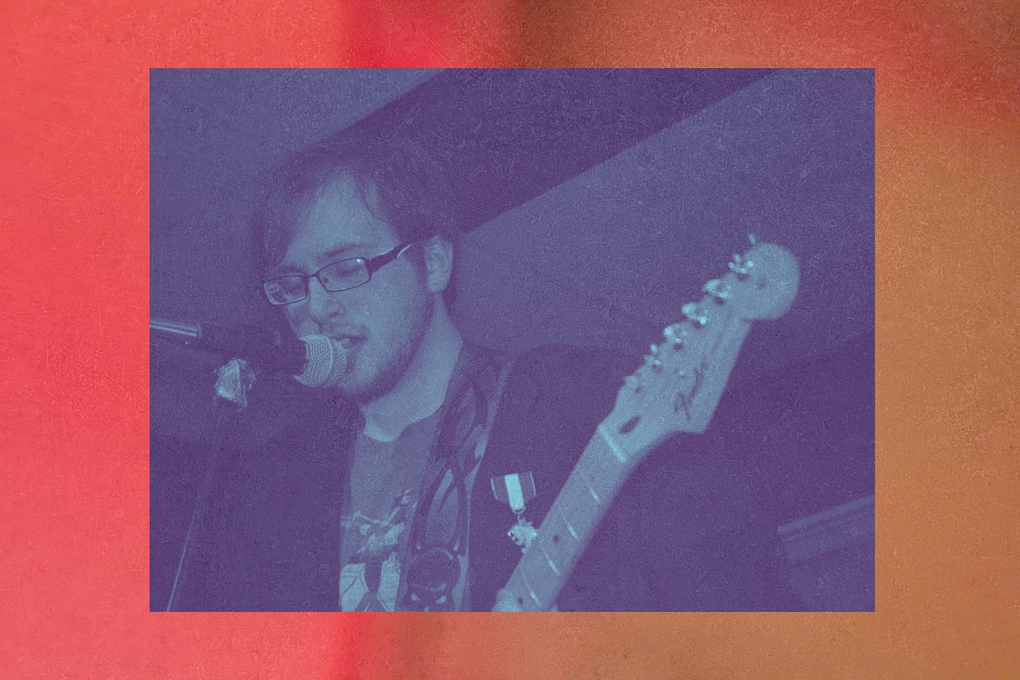 historical image of me at 19 playing guitar and singing with my band.