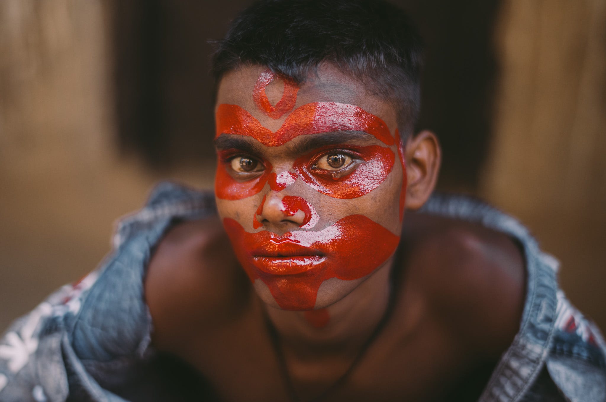 I asked this boy if I could make his portrait during the Gajan Festival. He agreed quietly. As I started photographing, the face paint irritated his eyes, and tears appeared. I paused and felt a deep connection to his innocence, and this photo will always remind me of such innocence.