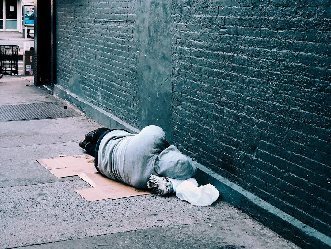 man lying on brown cardboard box