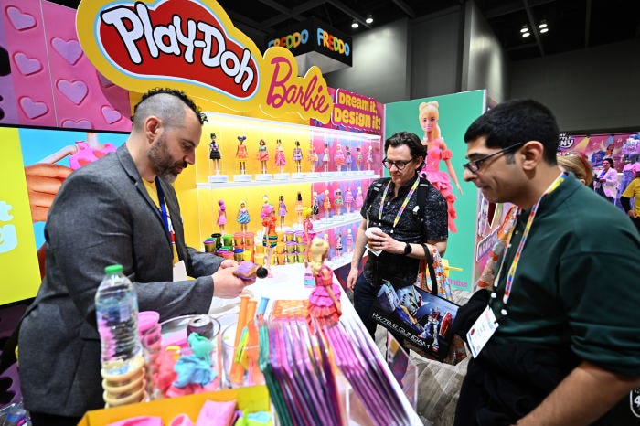 Hasbro booth at New York Toy Fair showcasing Play-Doh and Barbie.