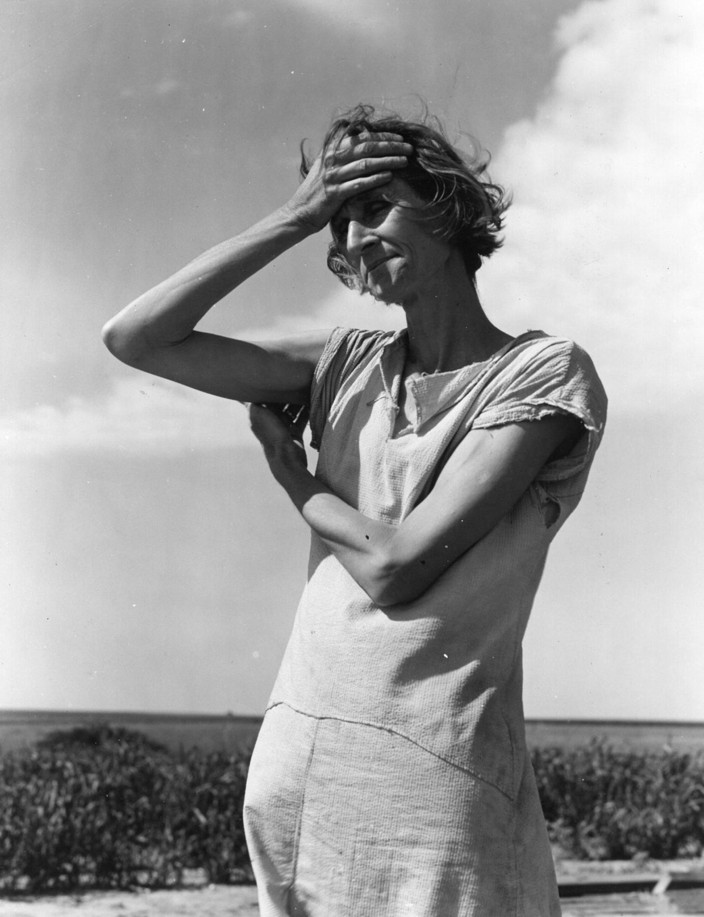 A person holding her head

Description automatically generated