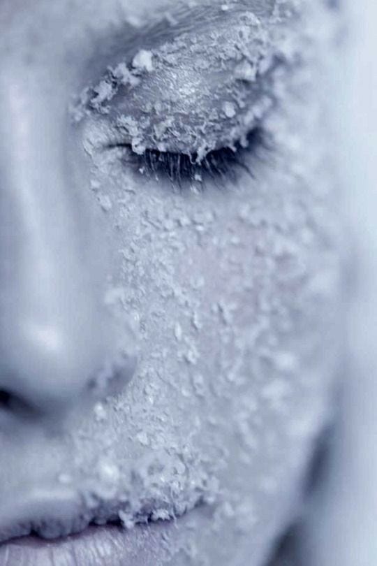 This may contain: a woman's face covered in white powder