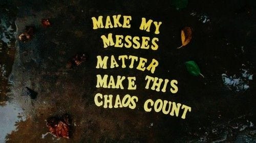 This may contain: the words make my messes matter to make this chaos count written in yellow on a black surface
