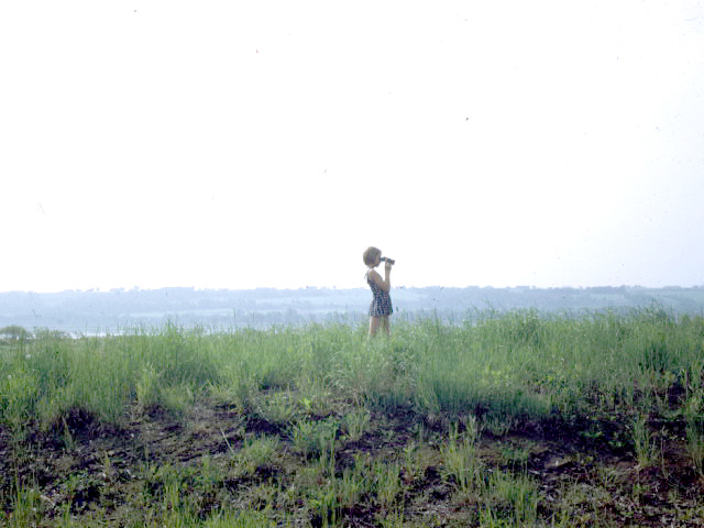 Young girl looking through binoculars