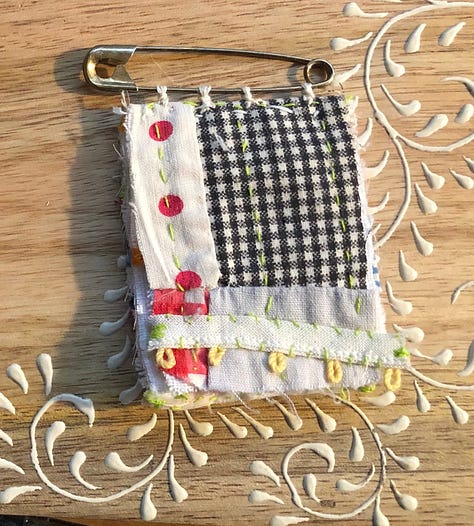 Tiny books and bunting, hand stitched from colorful vintage baby clothes.