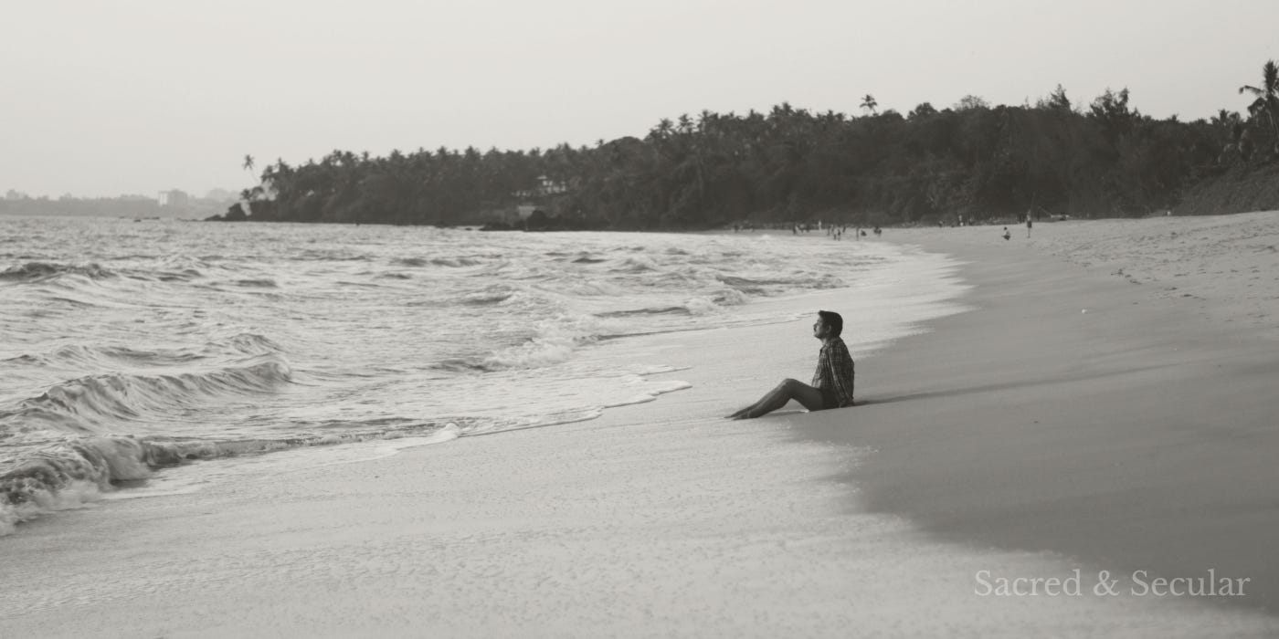 A solitary figure sits on a quiet shoreline, gazing out across the sea beneath a muted sky. Gentle waves roll onto the beach, creating a reflective and contemplative scene that evokes wonder, mystery, and stillness. A solitary figure sits on a quiet shoreline, gazing out across the sea beneath a muted sky. Gentle waves roll onto the beach, creating a reflective and contemplative scene that evokes wonder, mystery, and stillness.
