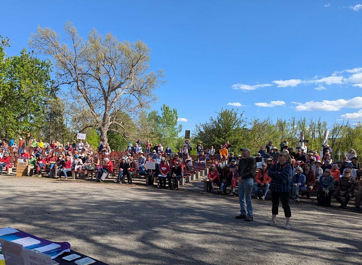 From top left, clockwise: a woman in a cowboy hat and a pink vest holds a sign reading "End The Trump Chaos Cruelty Corruption, Vote Blue in 2026, Impeach the Grifter-in-chief, a choral group with sound equipment and songsheets performs in a half-shell - they have a banner identifying themselves as the Singing Resistance: Boulder; a banner at a table for Soboco Indivisible, modeled after the American flag, reading Join Us, Stand Up, Fight Back; a large crowd of protesters gathered along the street.