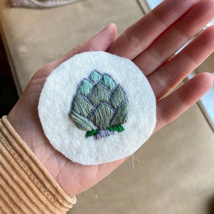 Embroidered Christmas ornaments depicting a bunny, a wreath, a whisk, a trumpet, a can of beans, and an artichoke