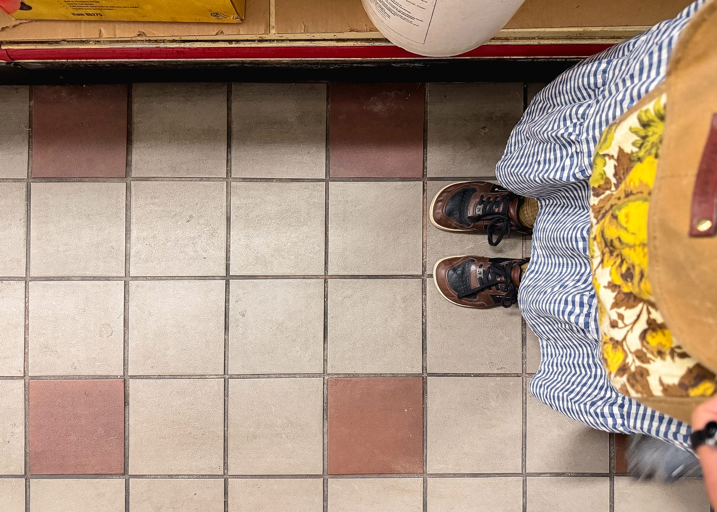 my feet on an old deli floor 