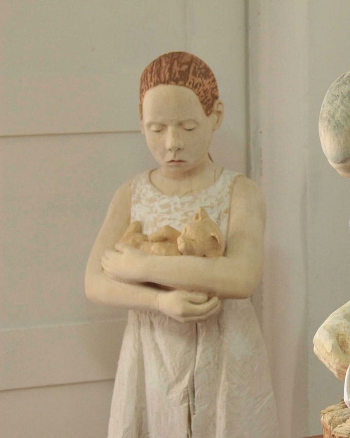 Figurative wood sculpture by Tina Schneider, blending organic form with raw emotional presence. Image courtesy of the artist.