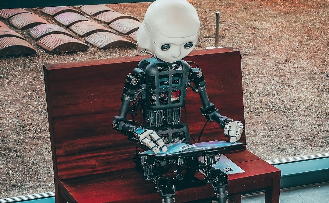 black and white robot toy on red wooden table